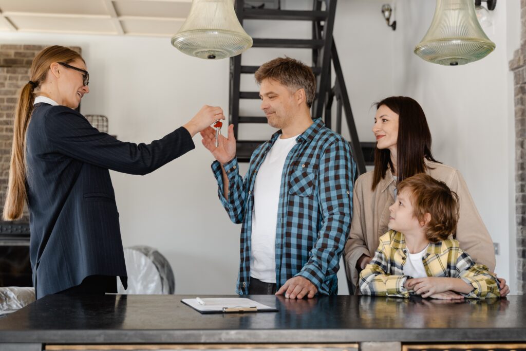 A great real estate agent is giving a family the keys to their new house