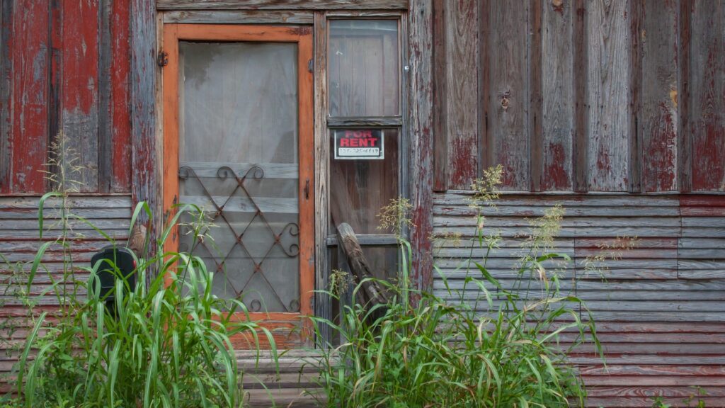 Rent or Sell: Facade of a House with a sign House for Rent