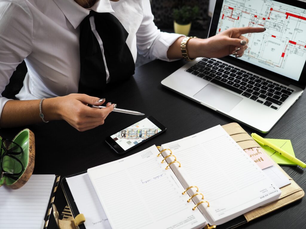 Homeownership Rate: A real estate agent is pointing to her laptop 